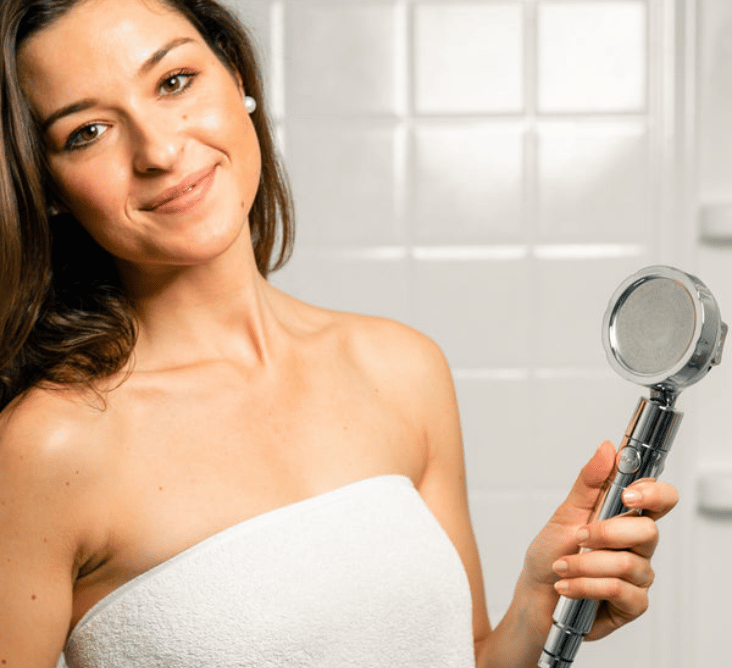 Woman with high pressure chrome showerhead